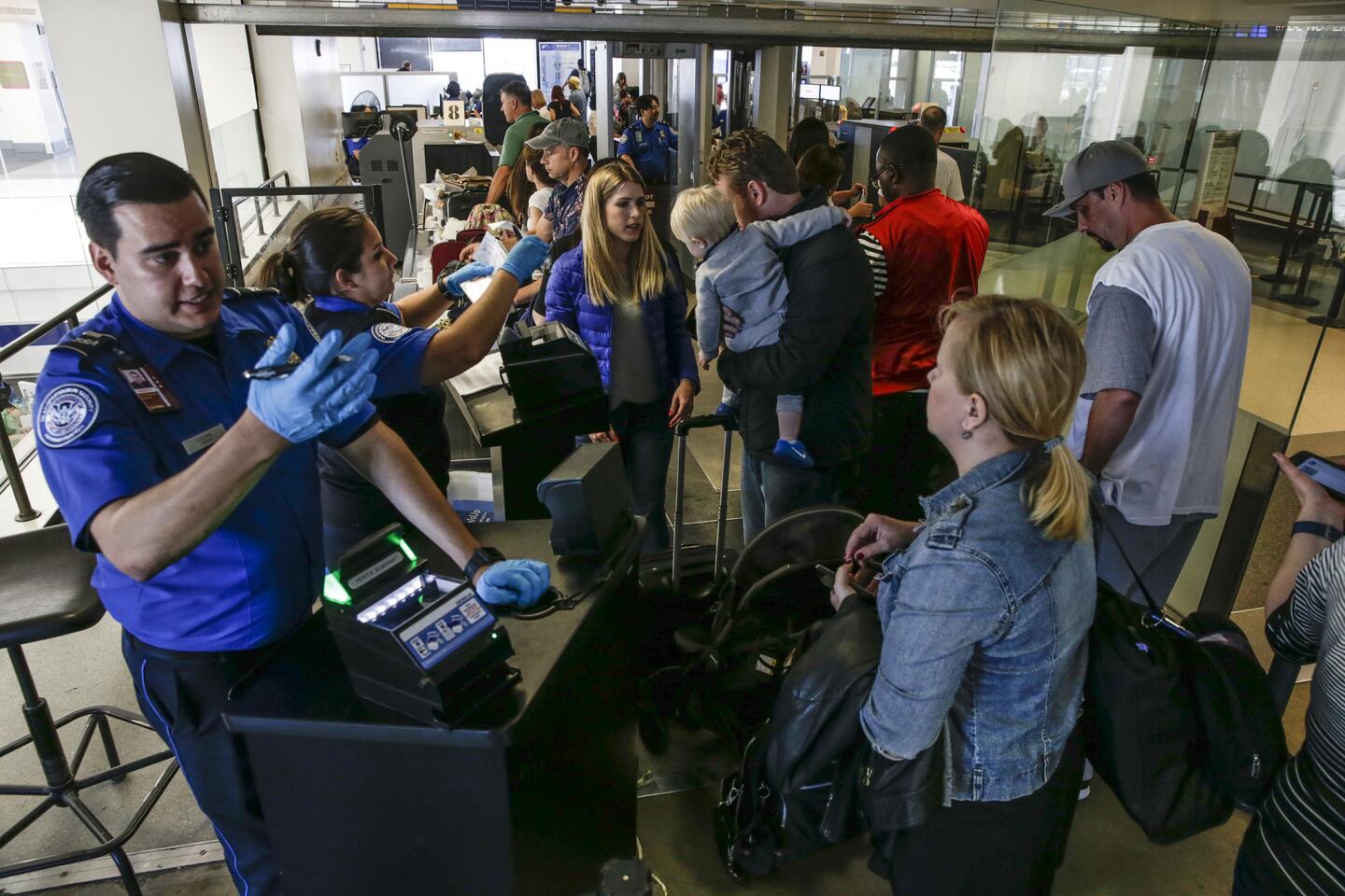 Memorial Day weekend travelers line up at a TSA checkpoint at the United Airlines Terminal at LAX.