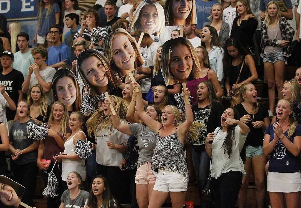 Newport Harbor High students cheer for their team during the Battle of the Bay girls' volleyball match on Saturday.