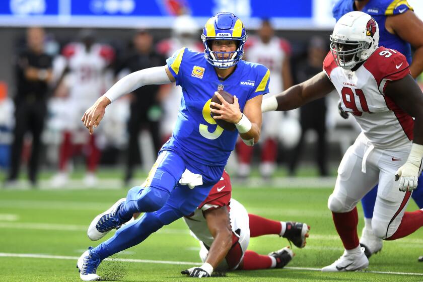 Inglewood, CA. October 3, 2021: Rams quarterback Matthew Stafford scrambles for a first down against the Cardinals.