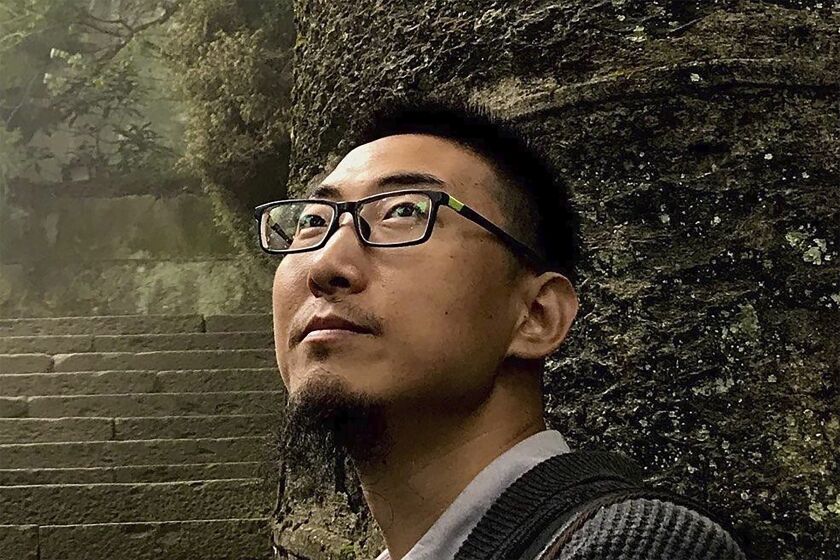 In this photo released by #FreeXueBing, Wang Jianbing is seen in a photo taken in Lushan in southeastern China's Jiangxi province, in June 2017. Wang who helped women report sexual harassment, has been detained since September. In China, He is just one of several people, activists and accusers alike, who have been hustled out of view, charged with crimes or trolled and silenced online for speaking out about the harassment, violence and discrimination women face every day. (#FreeXueBing via AP)