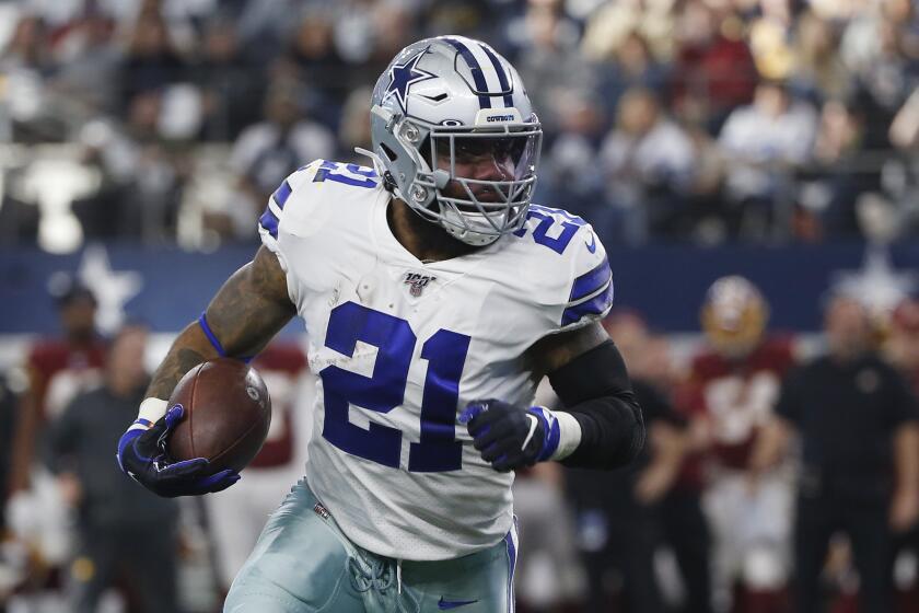 Dallas Cowboys running back Ezekiel Elliott (21) runs against the Washington Redskins during the first half of an NFL football game in Arlington, Texas, Sunday, Dec. 15, 2019. (AP Photo/Ron Jenkins)