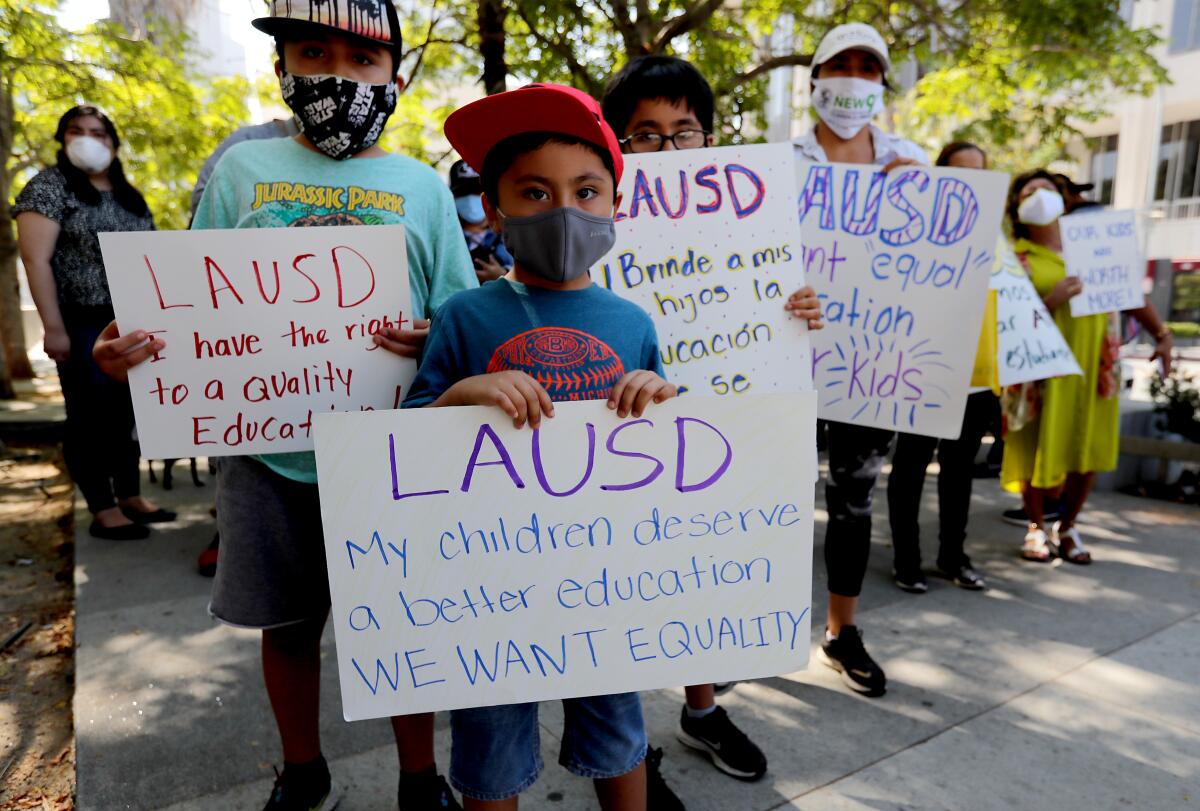 Parents, students and hold sign calling for education equity. 