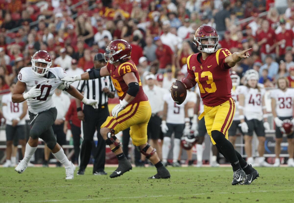 USC offensive lineman Jonah Monheim blocks a defender while Caleb Williams looks to pass the ball