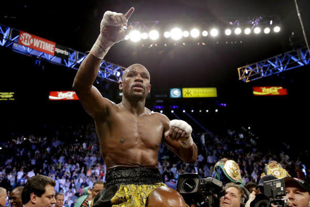 Floyd Mayweather Jr. reacts after defeating Robert Guerrero by unanimous decision in a WBC welterweight title fight.