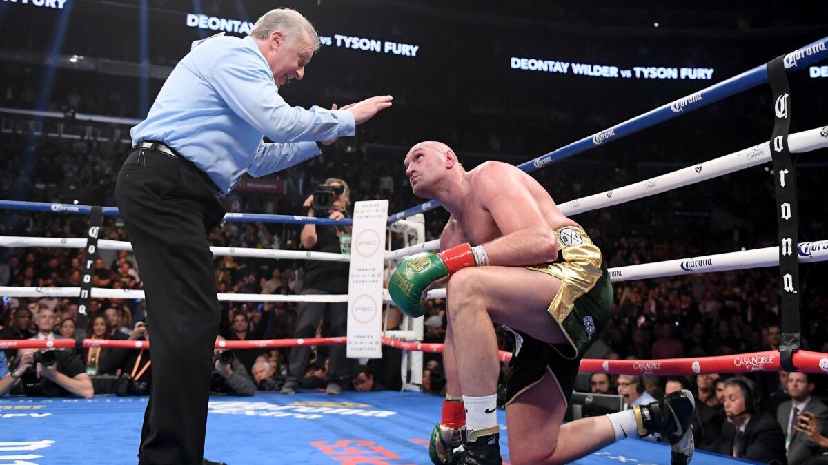 Tyson Fury looks up as he receives a count from referee Jack Reiss in the ninth round.