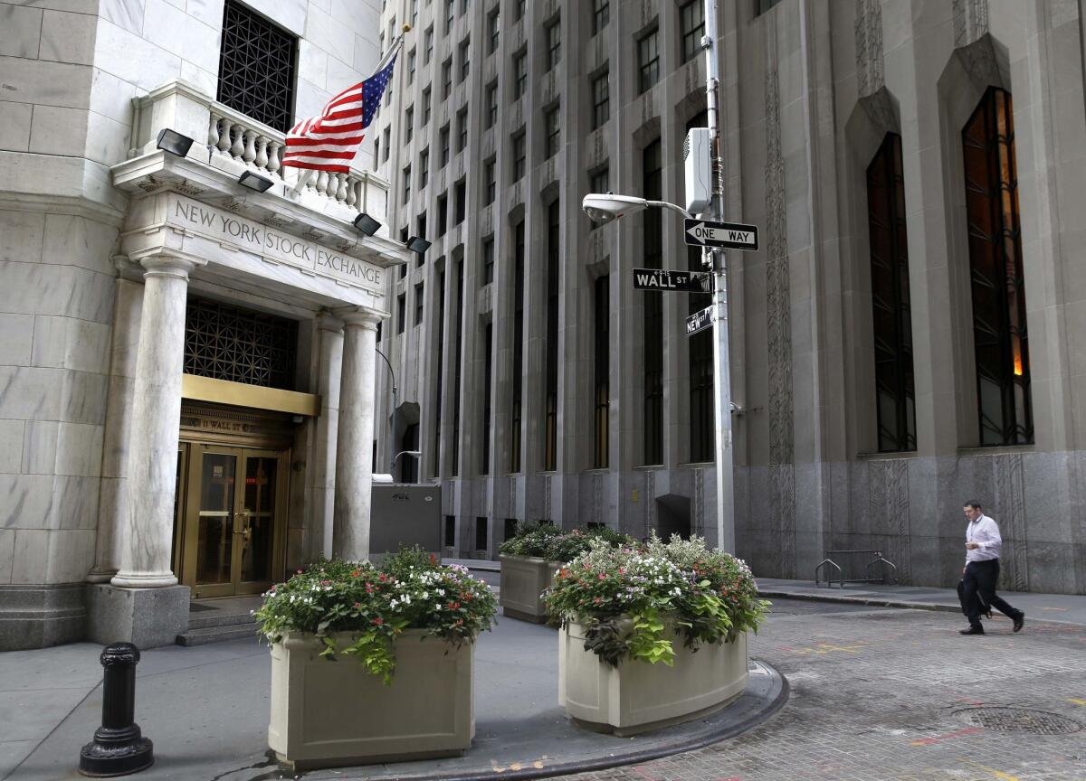 A man walks toward an entrance to the New York Stock Exchange on Aug. 24, 2015.