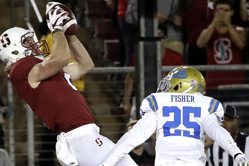 Cardinal wide receiver Trenton Irwin makes against UCLA defensive back Denzel Fisher during the second half.