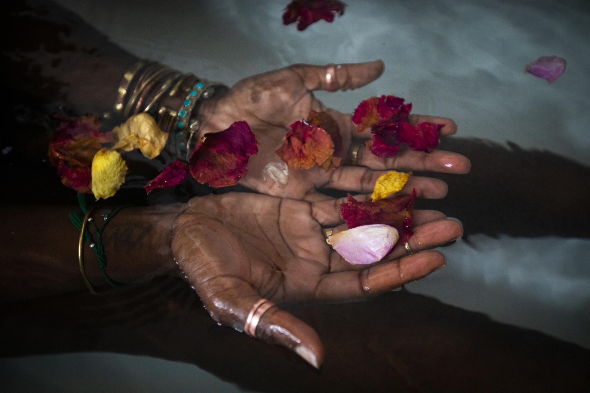 Alua Arthur soaks in the warm water after preparing a bath including candles and rose petals.