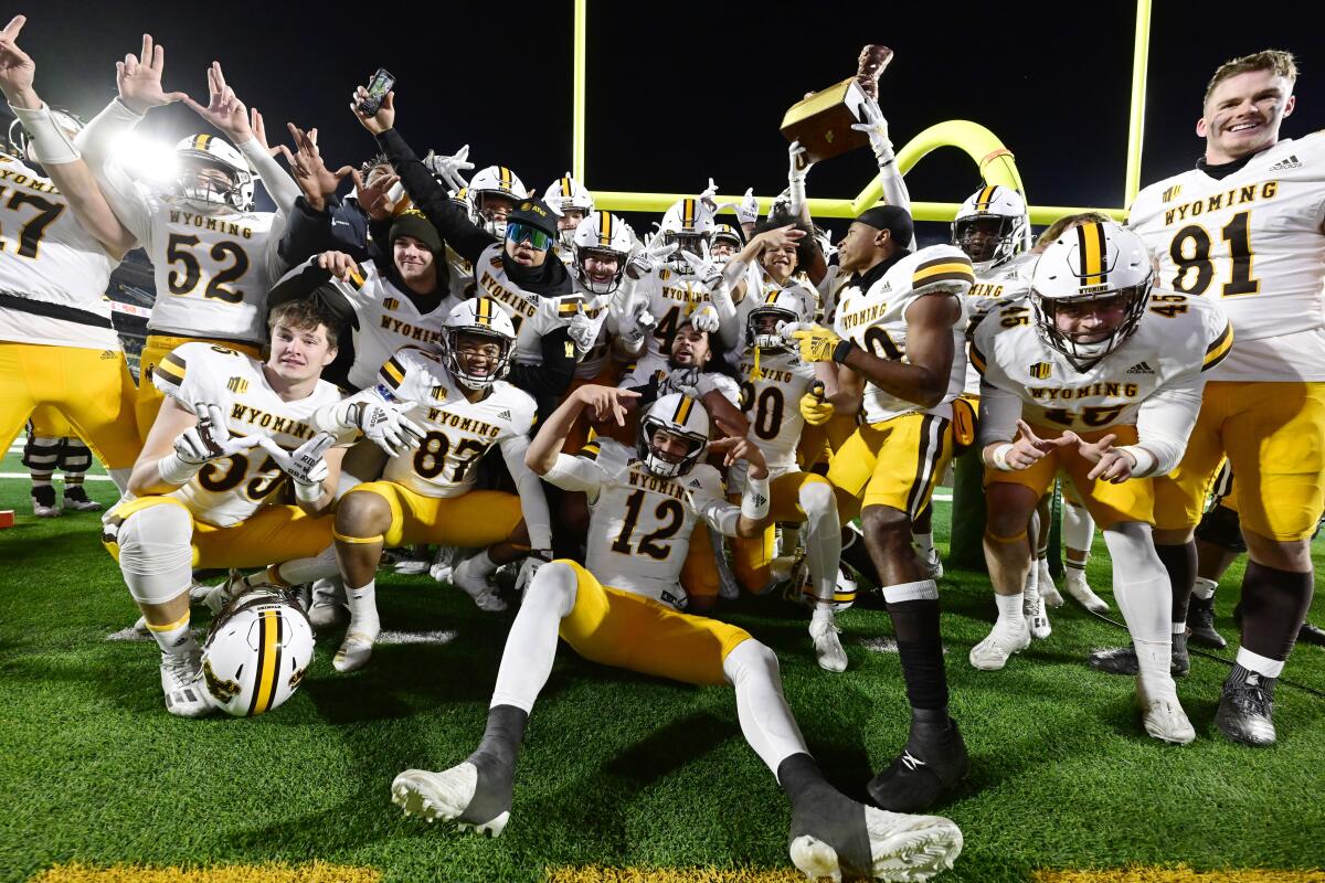 Wyoming celebrates after defeating Colorado State in an NCAA college football game Saturday, Nov. 12, 2022, in Fort Collins, Colo. (Andy Cross/The Denver Post via AP)