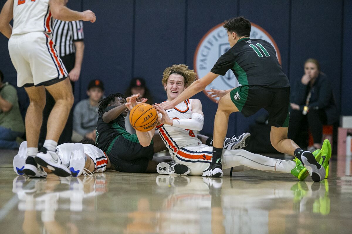 Pacifica Christian Orange County's Parker Strauss battles for a loose ball against Fairmont Prep's Oliver Jones on Friday.
