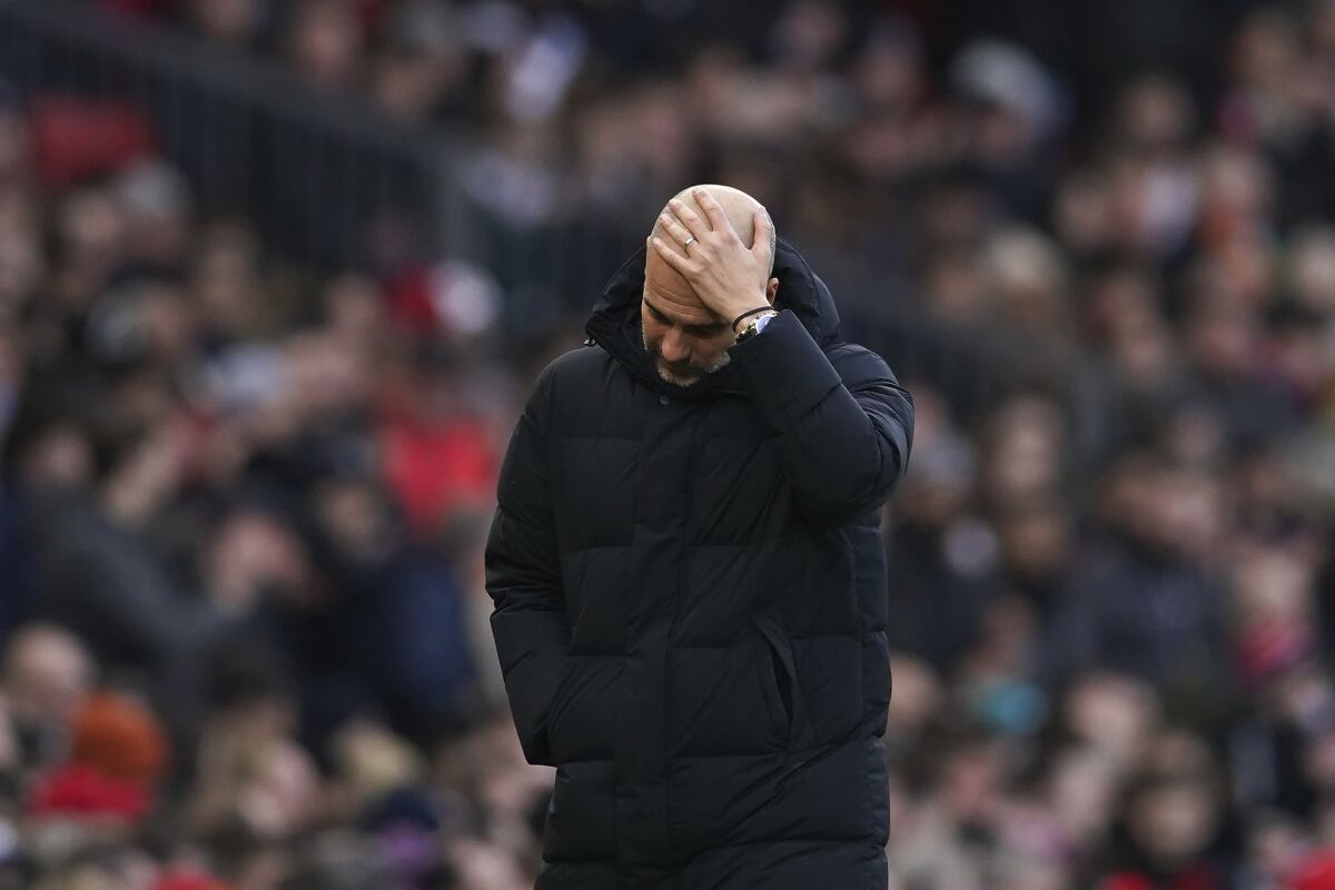 Manchester City's head coach Pep Guardiola reacts during the English Premier League soccer match between Manchester United and Manchester City at Old Trafford in Manchester, England, Saturday, Jan. 14, 2023. (AP Photo/Dave Thompson)