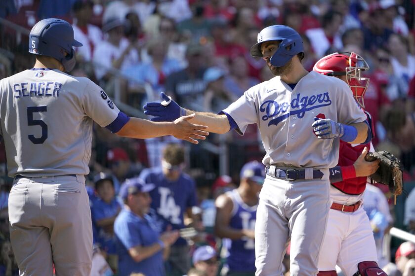 Los Angeles Dodgers' Chris Taylor, right, is congratulated by teammate Corey Seager (5) after hitting a two-run home run during the first inning of a baseball game against the St. Louis CardinalsMonday, Sept. 6, 2021, in St. Louis. (AP Photo/Jeff Roberson)