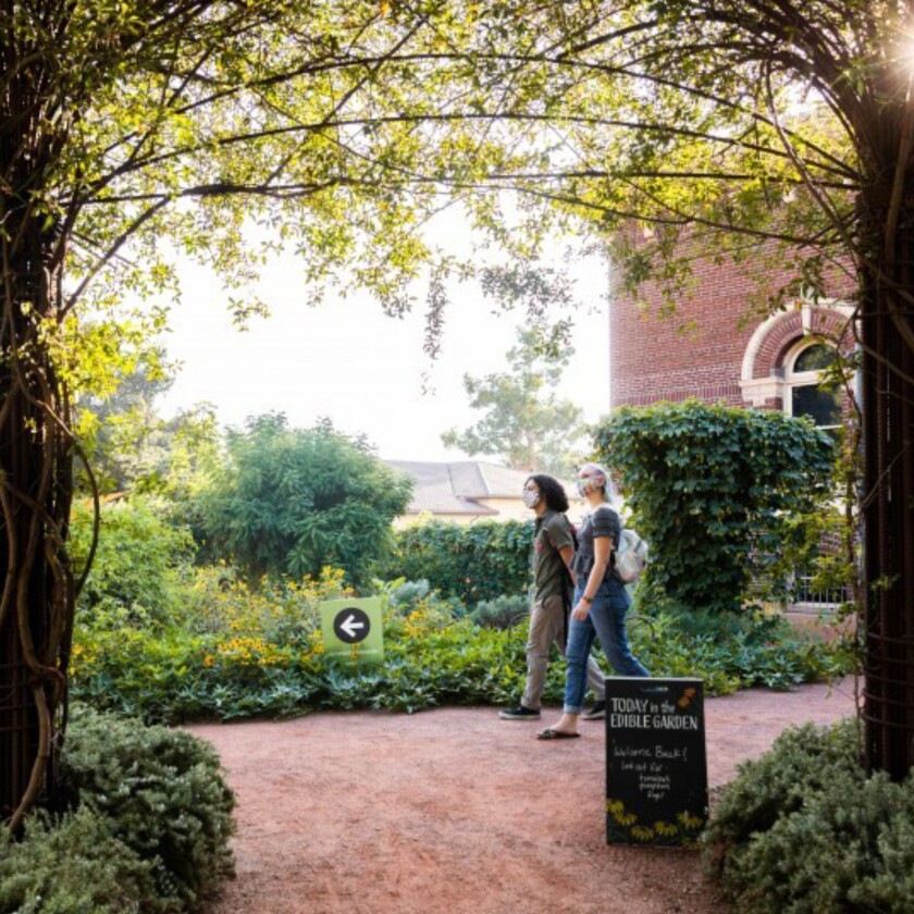 A couple strolls outside the Natural History Museum of L.A. County.