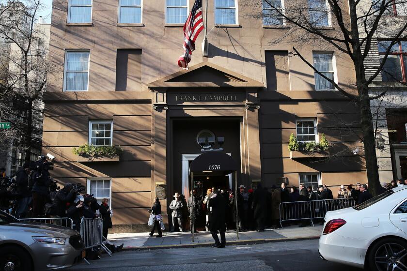 People wait to enter a Manhattan funeral home to pay their respects to former Gov. Mario Cuomo.
