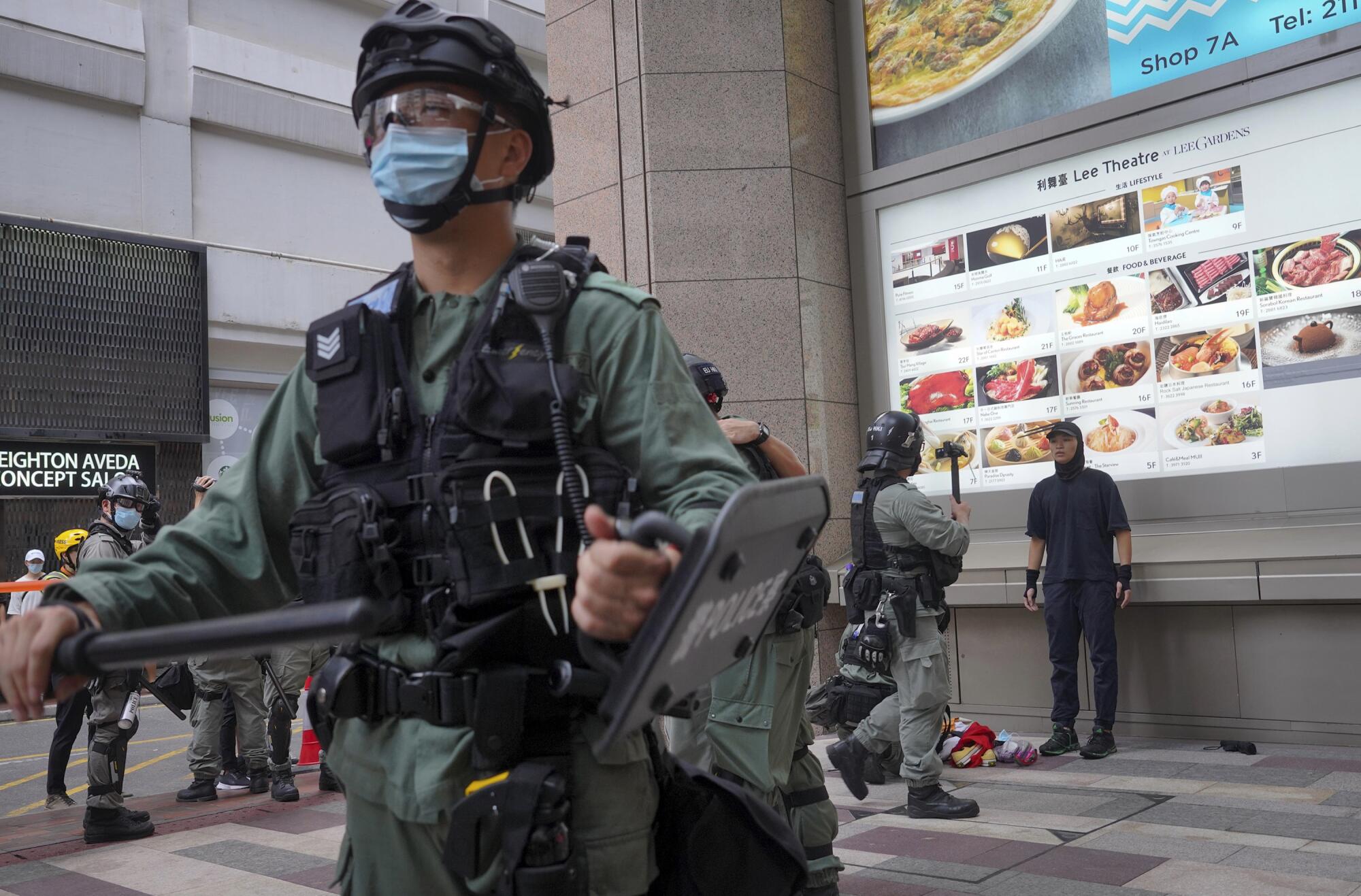 Police detain protesters during the annual handover march in Hong Kong on Wednesday.