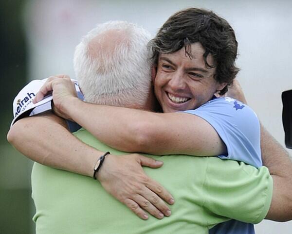 Rory McIlroy gives his father Gerry a hug on the 18th green after winning the 111th U.S. Open, his first major championship.
