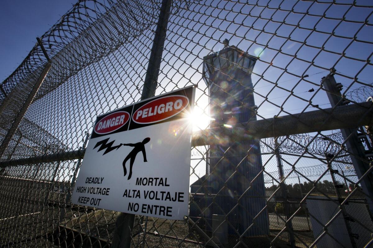 A sign warns inmates, staff and visitors that this portion of fencing at Pelican Bay State Prison in Crescent City, California is electrified.