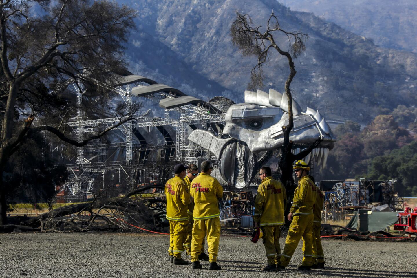 Cal Fire firefighters meet near the massive movie set of "Ultimate Beastmaster," a Netflix series, that survived the Sand fire, which tore through Sable Ranch in Santa Clarita.