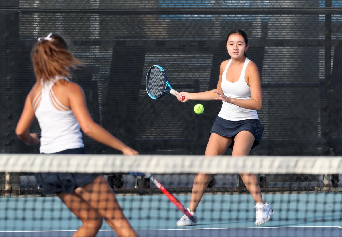 Corona del Mar doubles players Lena Pham, right, and Cate Montgomery, left, compete against Laguna Beach.