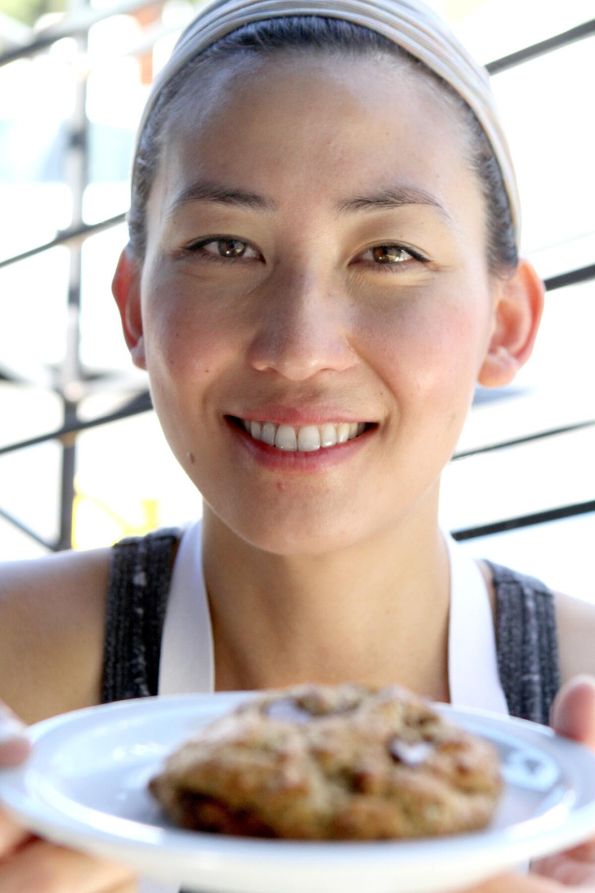 Pastry chef Naomi Shim holds one of her German Chocolate cookies on Tuesday, September 16, 2014.
