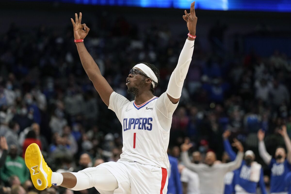 Los Angeles Clippers guard Reggie Jackson (1) celebrates after scoring a 3-point basket against the Dallas Mavericks during the fourth quarter of an NBA basketball game in Dallas, Saturday, Feb. 12, 2022. (AP Photo/LM Otero)
