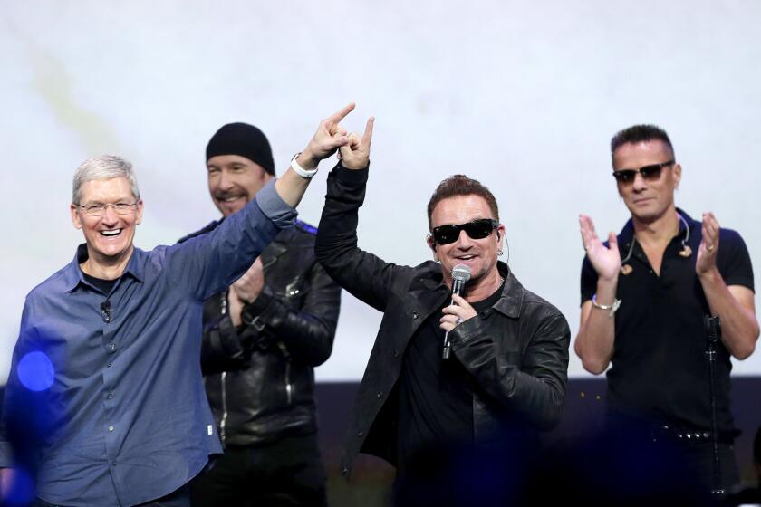 Apple CEO Tim Cook with Bono, the Edge, Larry Mullen Jr. at the Apple product announcement last week.