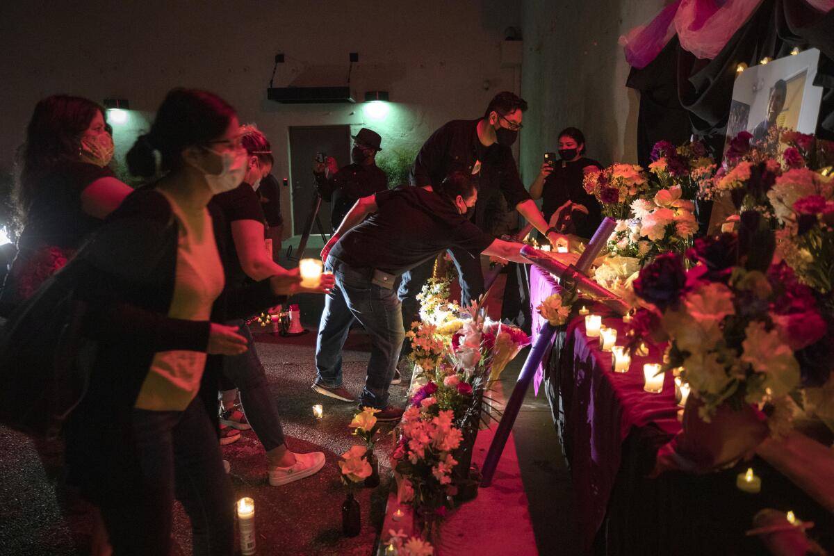 Candles are placed during a vigil for José Tomás Mejía near downtown Los Angeles in June 2021.