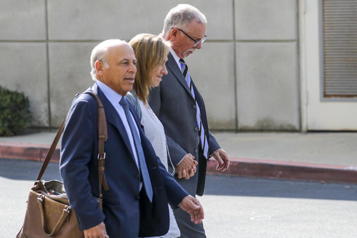 Former UCLA gynecologist Dr. James Heaps, right, leaves Airport Superior Court in 2019.