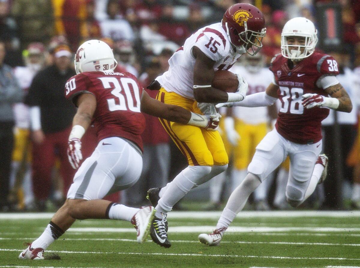 USC's Nelson Agholor, shown breaking a tackle attempt by Washington State's Taylor Taliulu, caught eight passes for 220 yards, including an 87-yard touchdown reception, with a 65-yard punt return for a touchdown as well.