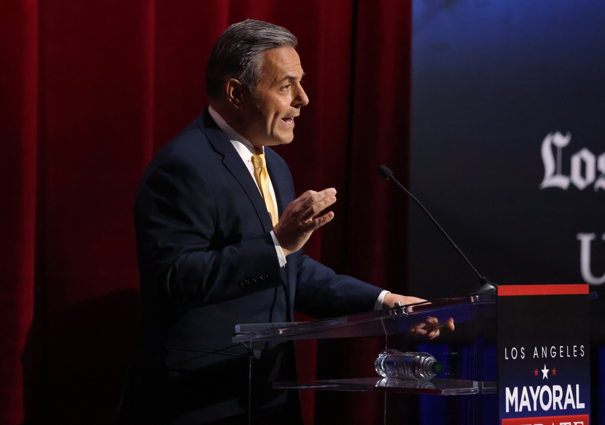 Joe Buscaino, city councilman, talks about the homelessness issue during the candidates' debate at USC's Bovard Auditorium 