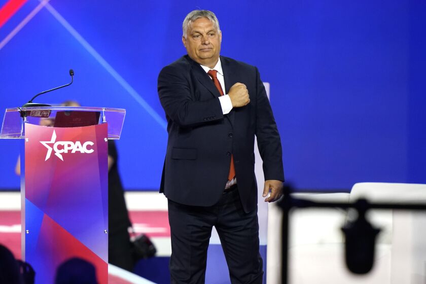 Hungarian Prime Minister Viktor Orban gestures with his fist on his chest after speaking at CPAC.