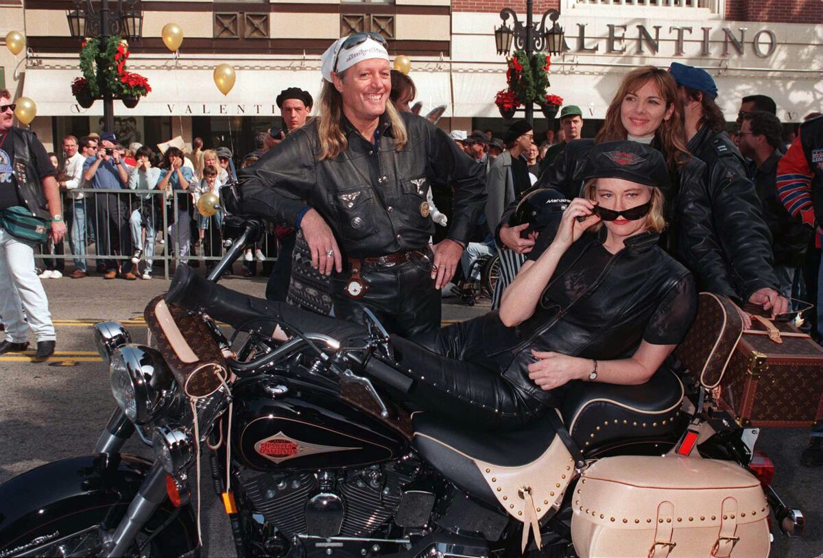 Peter Fonda, left, and Cybill Shepherd, seated, with a Louis Vuitton-outfitted Harley-Davidson in Beverly Hills in 1995.