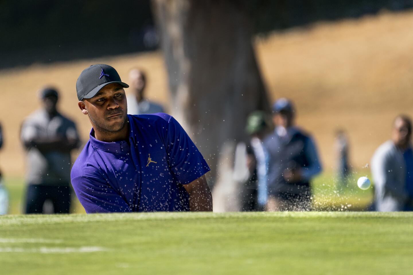 Harold Varner III hits out of a bunker and onto the 10th hole green during the final round of the Genesis Invitational at Riviera Country Club on Feb. 16, 2020.