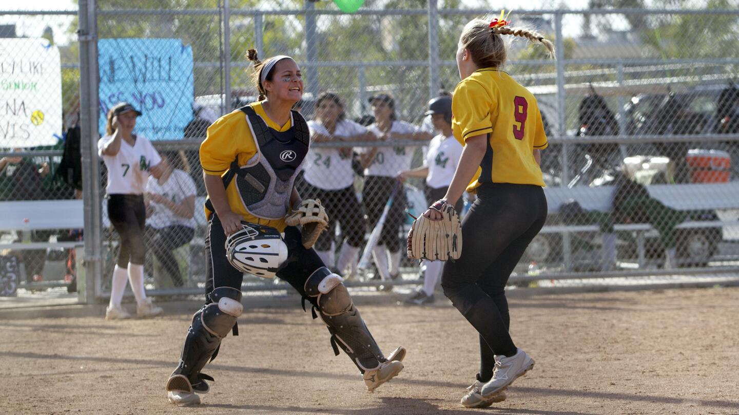 Estancia High catcher Kalena Sheperd, left, cheers with pitcher Brittany Walker (9) after the Eagles defeat the Costa Mesa Mustangs in the Battle for the Bell softball game on Monday.