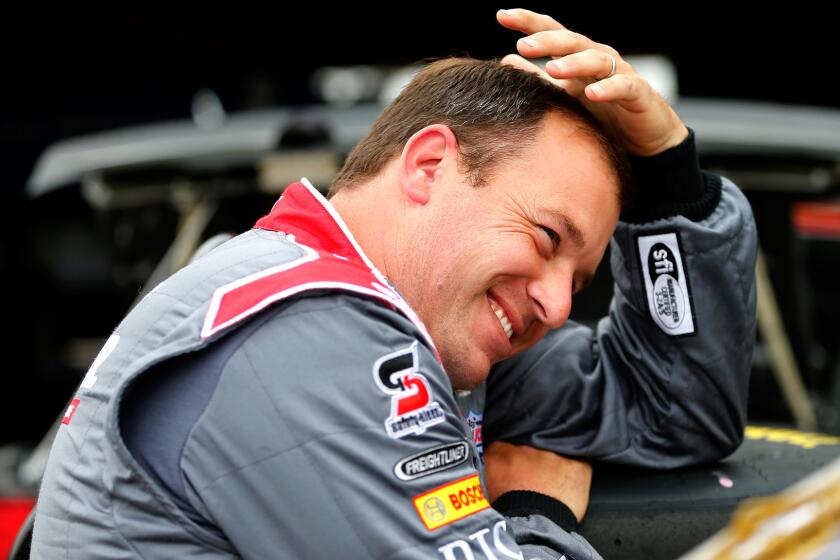 NASCAR driver Ryan Newman waits in the garage area before practice for a Sprint Cup Series race in Richmond, Va.