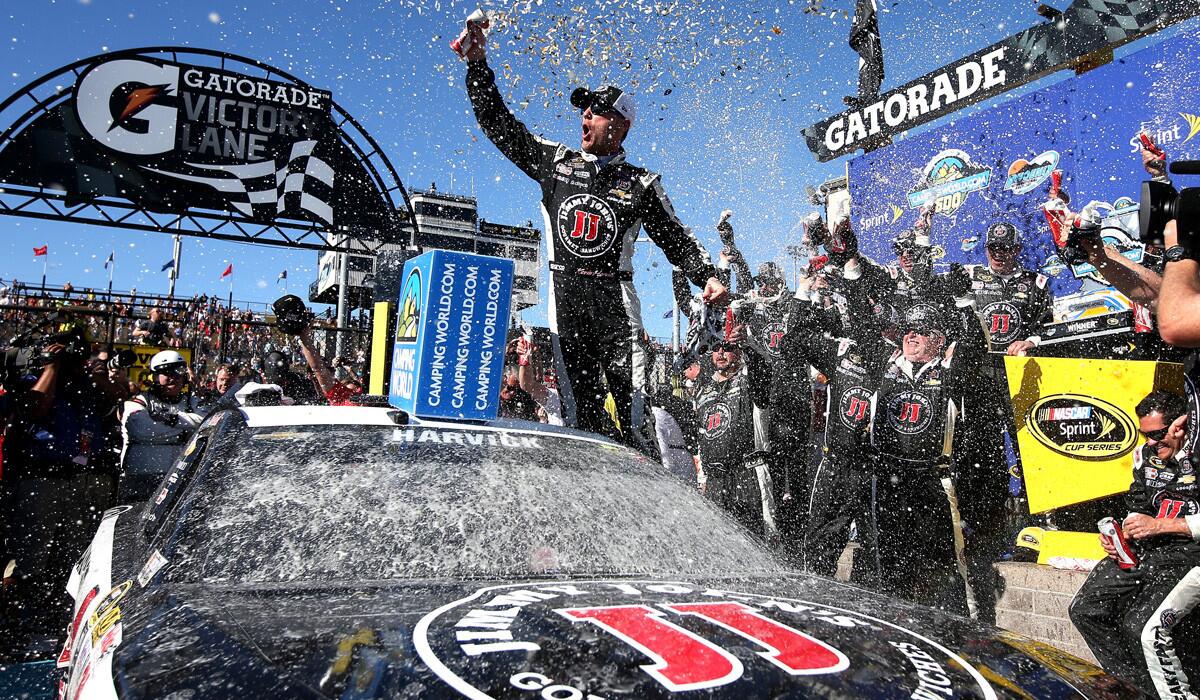 Kevin Harvick celebrates in Victory Lane after winning the NASCAR Sprint Cup Series CampingWorld.com 500 at Phoenix International Raceway on Sunday.