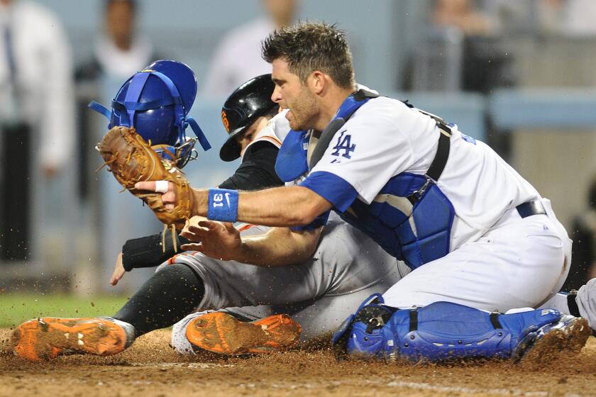 Dodgers catcher Drew Butera tags out San Francisco's Brandon Belt in September.