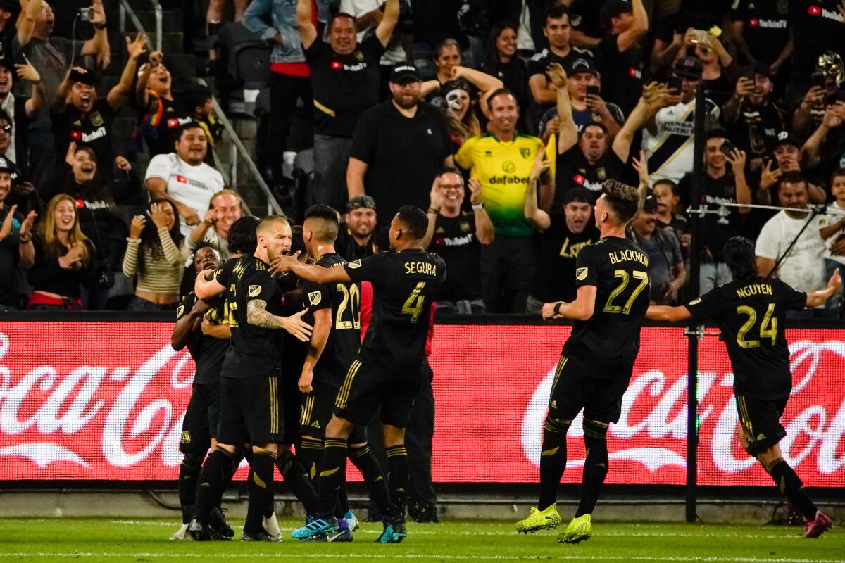 LAFC players celebrate a goal by Carlos Vela (10) during the 16th minute of their MLS Cup conference semifinal victory.