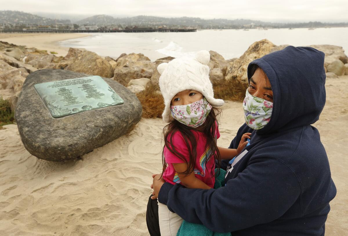 A woman and a child wearing face masks