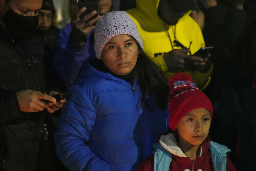 Migrants attend a vigil for the victims of a fire at an immigration detention center that killed dozens, in Ciudad Juarez, Mexico, Tuesday, March 28, 2023. According to Mexican President Andres Manuel Lopez Obrador, migrants fearing deportation set mattresses ablaze at the center, starting the fire. (AP Photo/Fernando Llano)