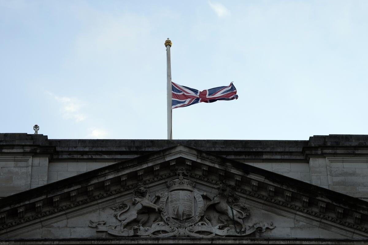 The Union flag on Buckingham Palace in London is lowered after the death of Britain's Queen Elizabeth II, Thursday, Sept. 8, 2022. Queen Elizabeth II, Britain's longest-reigning monarch and a rock of stability across much of a turbulent century, died Thursday after 70 years on the throne. She was 96. (AP Photo/Frank Augstein)