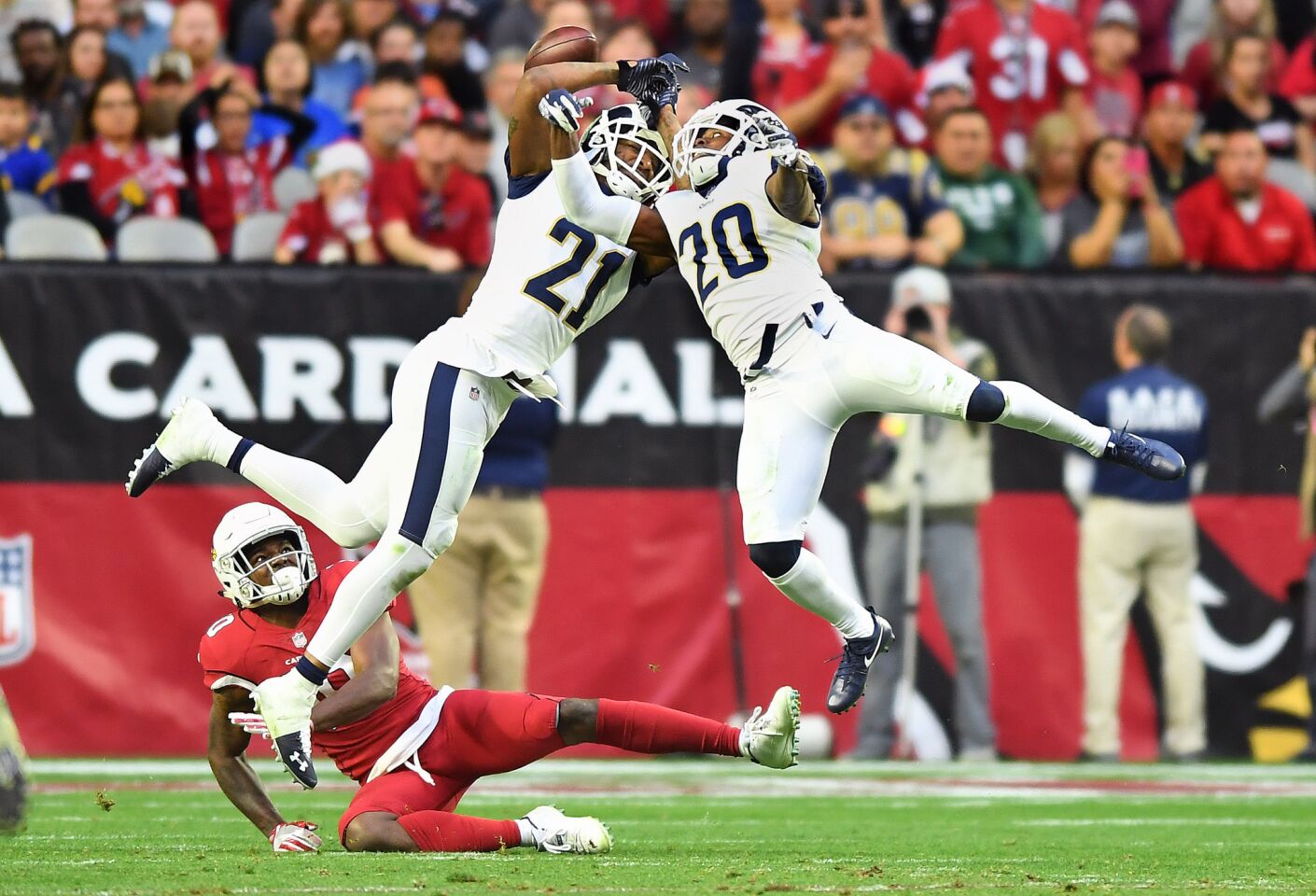Rams' Aqib Talib (21) and Lamarcus Joyner try to intercept a pass in front of Arizona Cardinals receiver Chad Williams in the fourth quarter at State Farm Stadium on Sunday.