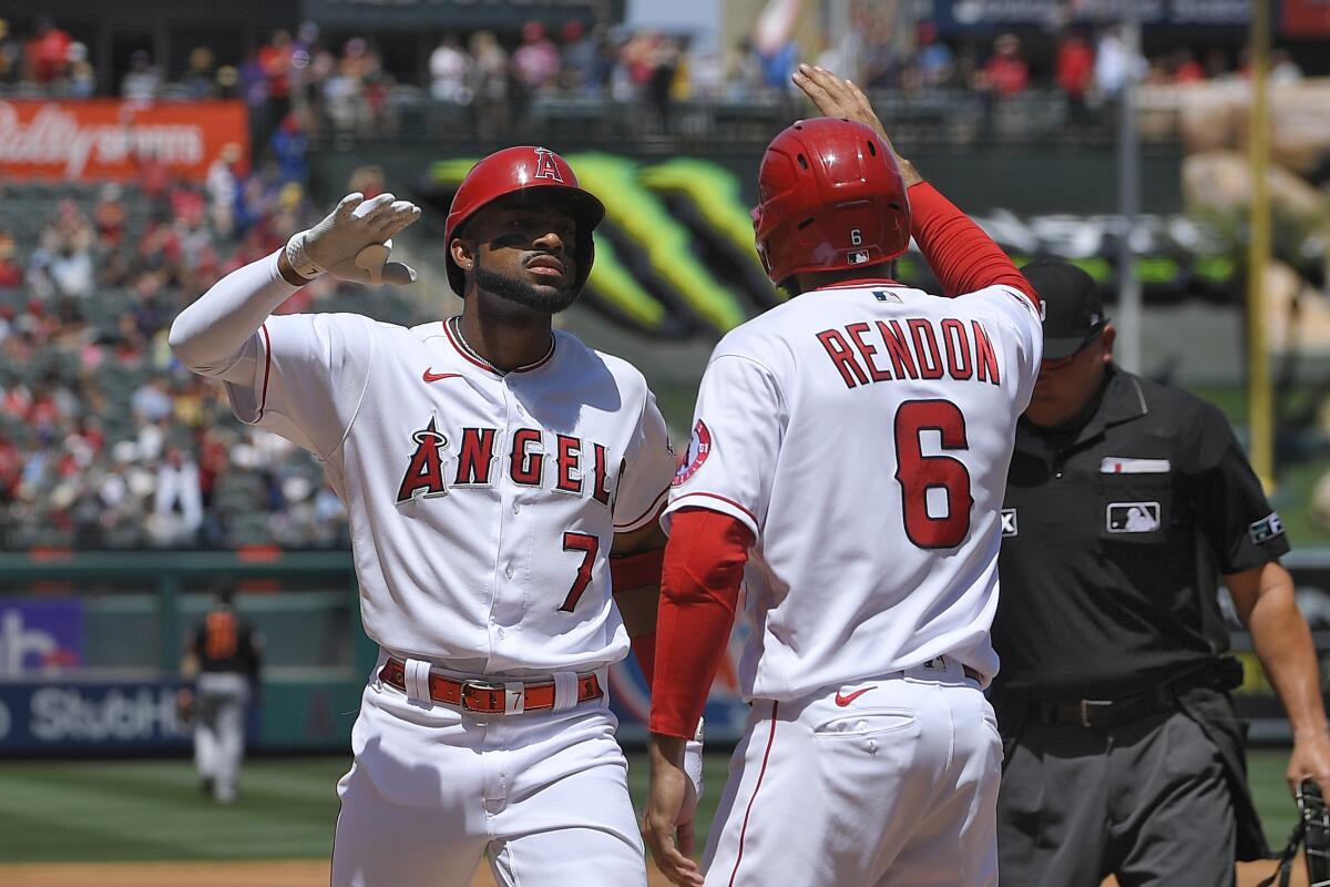 Th Angels' Jo Adell is congratulated by Anthony Rendon after hitting a grand slam.