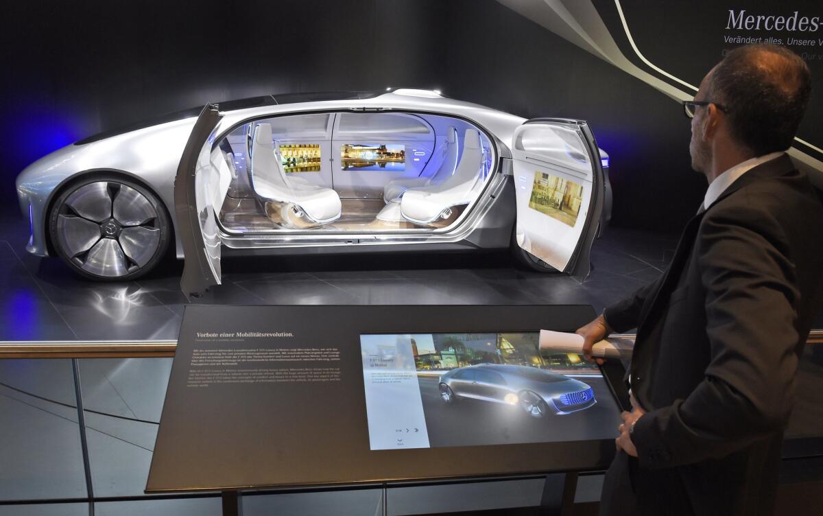 A visitor looks at the 'F 015 Luxury in Motion' autonomous driving vehicle at the Mercedes stand on the first press day of the Frankfurt Auto Show IAA in Frankfurt, Germany on Sept. 15.