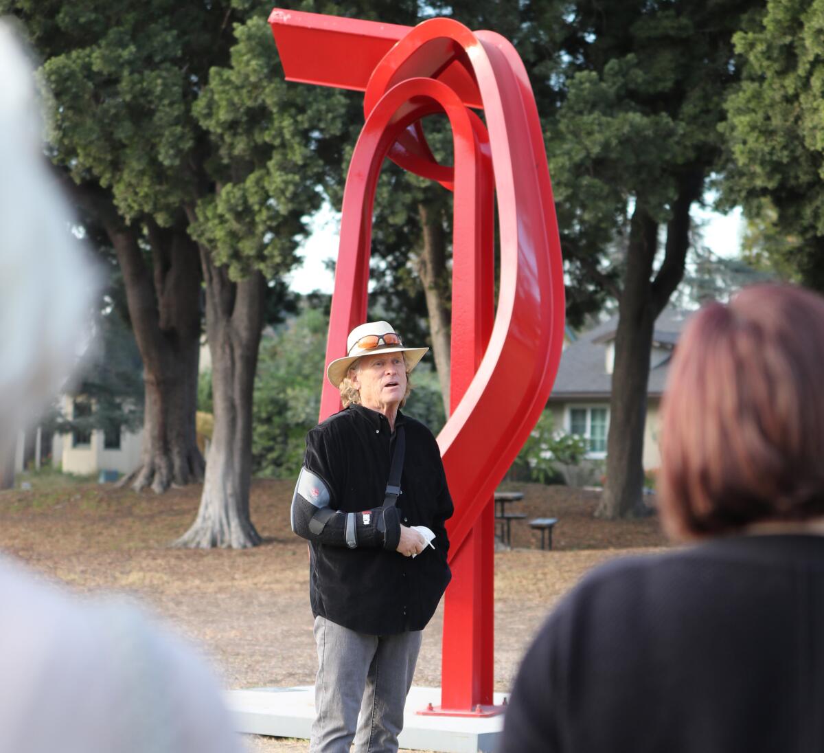 Artist Bret Price stands next to his piece titled "Godot" on Nov. 12.