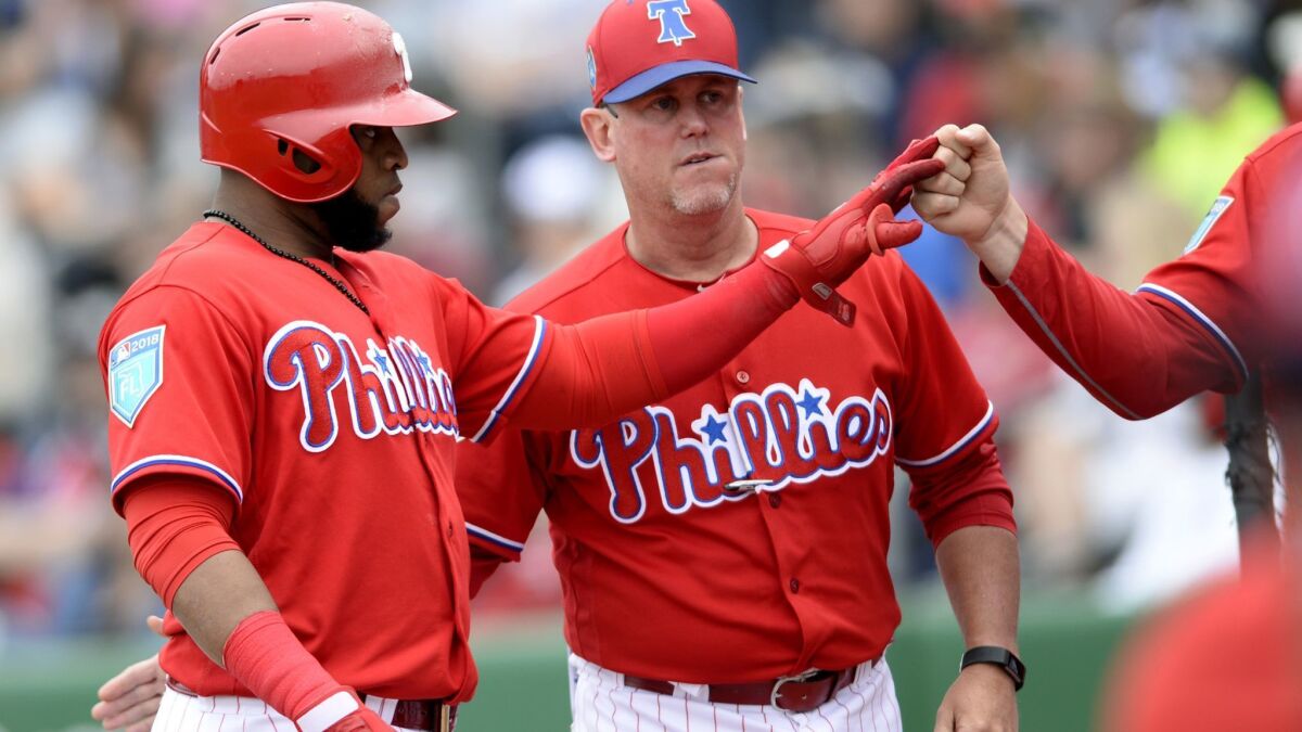 The Phillies Carlos Santana (41) is congratulated after his RBI sacrifice fly during the fifth inning of a spring training baseball game against the Tampa Bay Rays Saturday, March 10, 2018, in Clearwater, Fla.