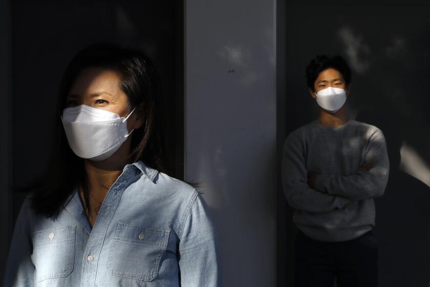 LA CANADA FLINTRIDGE-CA-DECEMBER 3, 2020: Soo Kim Choi, left, and her son Gavin Choi are photographed at La Cañada High School on Thursday, December 3, 2020. (Christina House / Los Angeles Times)