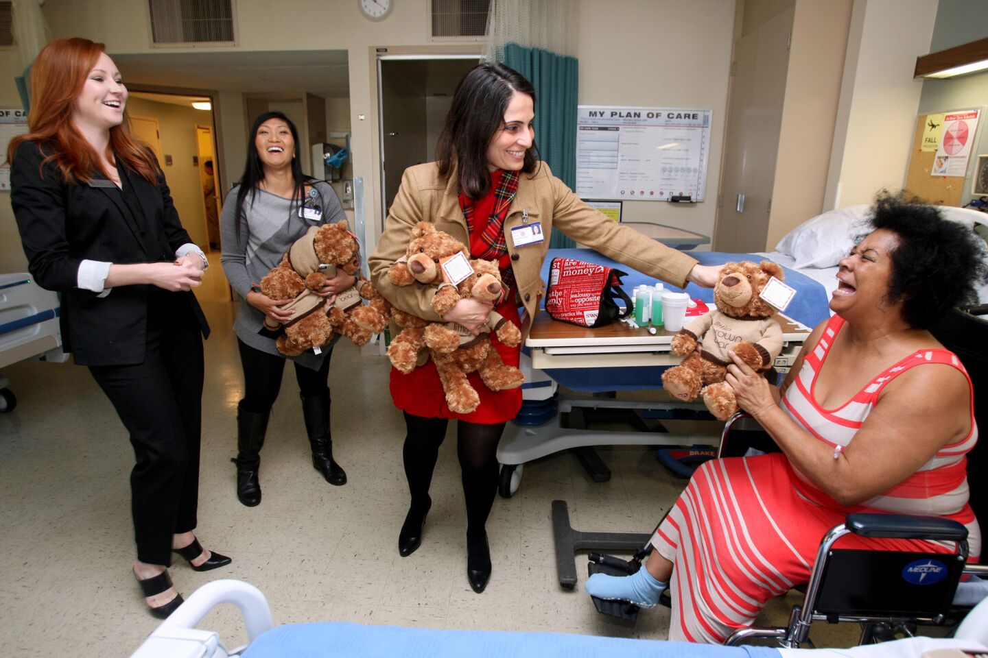 Bloomingdale's public relations manager Kelli Daley, left, Glendale Adventist Medical Center's Emillie Battig, RN, Director Nursing Admin., center, and Alina Dersarkissian, GAMC's director of marketing, present excited patient Cassandra Cañada, right, with a teddy bear for the holidays, at GAMC in Glendale on Wednesday, December 23, 2015. Sixty stuffed bears were handed out to patients throughout the hospital. A donor gave 30 bears and Bloomingdale's match the gift with another 30 bears.