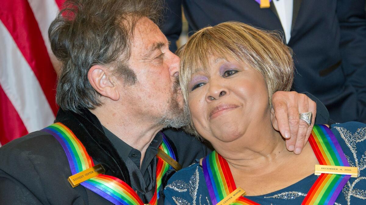 In the run-up to the Sunday ceremony, on Saturday Al Pacino gives a kiss to Mavis Staples following a dinner at the State Department in Washington, D.C.