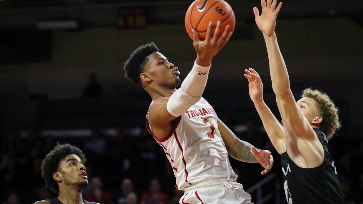 USC sophomore guard Elijah Weaver drives to the basket against Long Beach State forward Romelle Mansel.